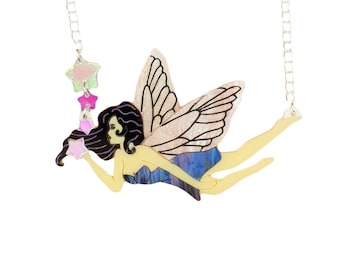 May include: A whimsical necklace featuring a fairy pendant with outstretched wings and a flowing blue dress. The fairy is holding a pink star, with a chain of stars hanging from the necklace. The necklace has a silver chain.