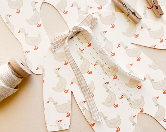 Little Goose Baby Shower Decorations, Goose Pajamas Banner with Ribbon Bows, 5 - 8 1/4"W x 9 3/16"H Pajamas, Adjustable Length, Neutrals
