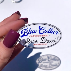 May include: A clear oval keychain with the text "Blue Collar - Superior Breed - Rare Breed" and "Made in the U.S.A." in blue and red lettering.