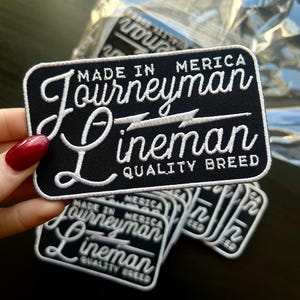 Può includere: Toppa ricamata in bianco e nero con il testo "Made in Merica Journeyman Lineman Quality Breed".