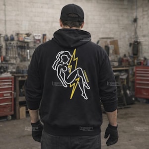 May include: Black hoodie with a white outline illustration of a woman and a yellow lightning bolt on the back. The text "LYNNGROVE" is printed below the illustration. The person in the image is wearing a black cap and gloves.