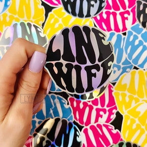 May include: A collection of colorful round stickers with the text "Line Wife" in a psychedelic font. The stickers are iridescent and have a glossy finish.