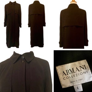 May include: A long black trench coat with a button closure and a collar. The coat has a label that reads "ARMANI COLLEZIONI MADE IN ITALY" and a size tag that reads "6".