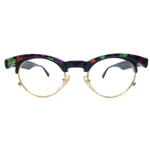 May include: Eyeglasses with a black frame and gold-colored rims. The upper frame is decorated with a floral pattern in green, orange, and purple. The lenses are clear.