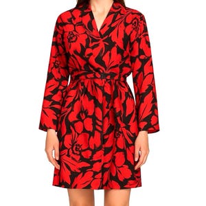 May include: A red and black floral print dress with long sleeves and a V-neck. The dress features a wrap-style waist and a knee-length hemline. The bold floral pattern is composed of large red flowers and black leaves.