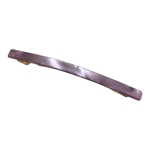 May include: A curved, lavender-colored hair barrette with a pearlescent finish. The barrette has gold-colored metal accents on each end, and is designed to hold hair in place. The barrette is a simple, elegant hair accessory.