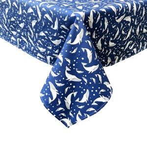 May include: A blue tablecloth with a white whale pattern. The tablecloth is made of a soft, durable fabric and is perfect for any occasion.