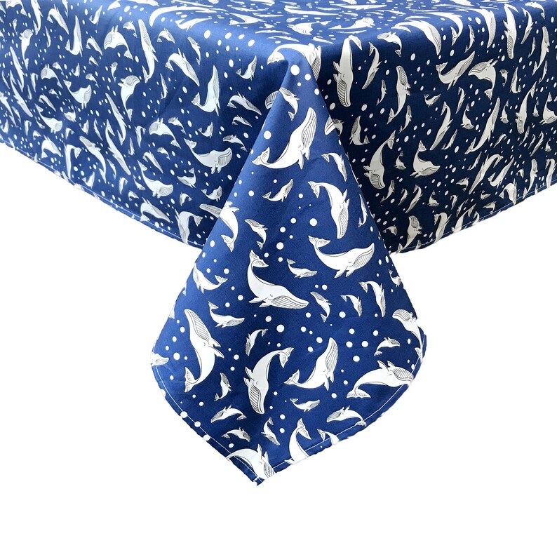 May include: A blue tablecloth with a white whale pattern. The tablecloth is made of a soft, durable fabric and is perfect for any occasion.