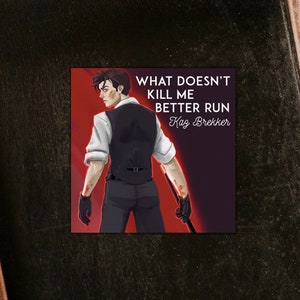 May include: A black and red graphic with a man in a black suit and white shirt. The text reads "What doesn't kill me better run Kaz Brekker".