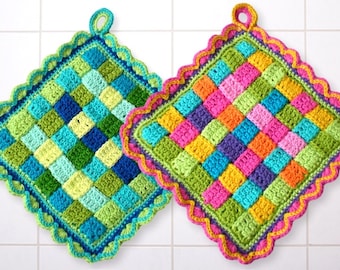 May include: Two colorful crocheted pot holders with scalloped edges and a loop handle. One pot holder is green, blue, and yellow, and the other is pink, orange, purple, and yellow.