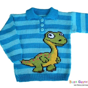 May include: A blue and light blue striped knitted sweater with a green dinosaur applique. The sweater has a collared neckline and button closure.