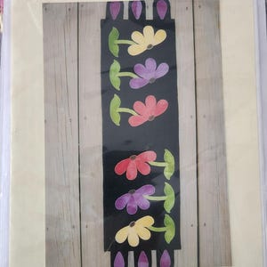 May include: A white ceramic mug with a black handle and the text "But First, Coffee" in a bold, black font. The mug is sitting on a wooden surface. The mug is 4 inches tall.