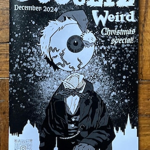 May include: Black and white illustration of a magazine cover with the title "Occultiz Weird" and the text "Christmas Special!"  The cover features a cartoon character with an eye for a head wearing a top hat and a bow tie. The magazine is titled "Oxford Comics, Cult & Zine Fair".