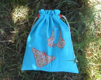 Turquoise canvas lingerie bag with Liberty Of London appliqué