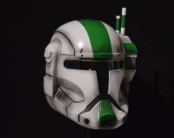May include: A white and green helmet with a black visor and a green stripe down the side. The helmet has a small antenna on top.