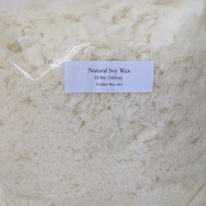 May include: A white plastic bag filled with white soy wax flakes. The bag has a label that reads "Natural Soy Wax 10 lbs (160oz) Golden Wax 464".
