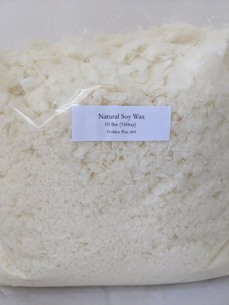 May include: A white plastic bag filled with white soy wax flakes. The bag has a label that reads "Natural Soy Wax 10 lbs (160oz) Golden Wax 464".