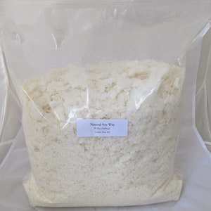 May include: A clear plastic bag filled with white soy wax flakes. The bag has a label that reads "Natural Soy Wax 10 lbs (160oz) Golden Wax 404".