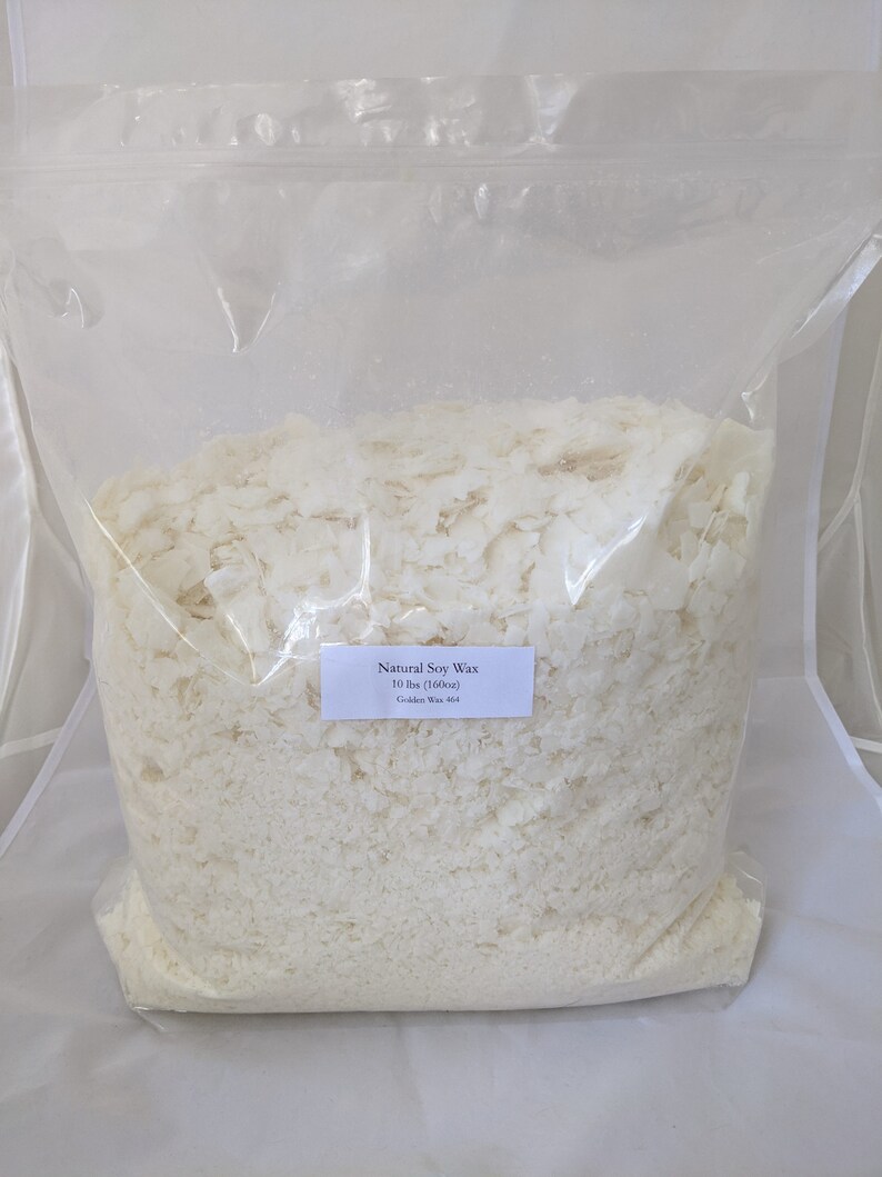 May include: A clear plastic bag filled with white soy wax flakes. The bag has a label that reads "Natural Soy Wax 10 lbs (160oz) Golden Wax 404".