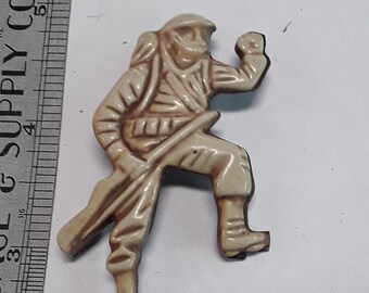 Gold toned plastic army man pin brooch used