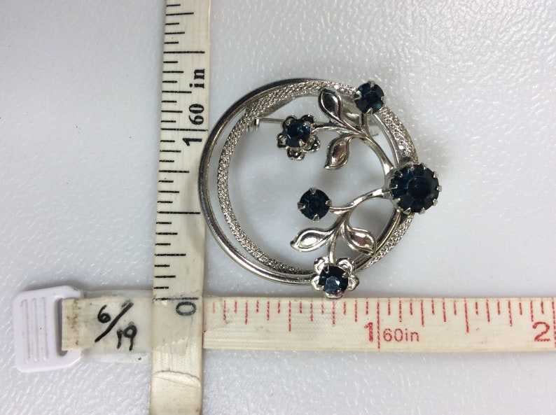 Vintage Silver Toned Pin Brooch Circle With Flowers And Blue Rhinestones Used