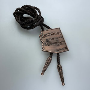 Vintage Bolo Tie Copper Toned Masonic Aztlan Lodge UD Grand Lodge Of California F And AM Brown Braided Vinyl Used