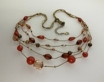 May include: Multi-strand necklace with gold chain and red, brown, and clear beads.