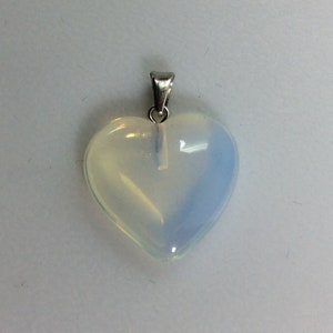May include: A heart-shaped opal pendant with a silver bail. The opal is a milky white color with a hint of blue.