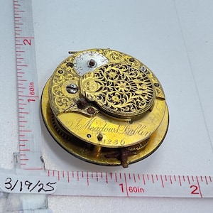 May include: A gold pocket watch with intricate floral engravings and the inscription "J Meadows Dublin 4236".