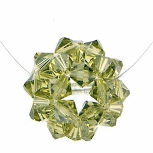 May include: A green crystal bead necklace with a star-shaped pendant. The necklace is made of small, faceted crystals that are strung together on a clear thread.