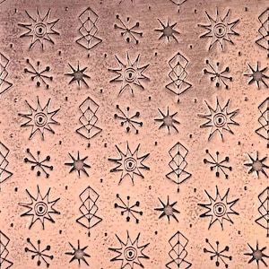 May include: A copper-colored metal sheet with an embossed pattern. The design features repeating star and geometric shapes, creating a textured surface. The pattern is evenly spaced across the sheet.