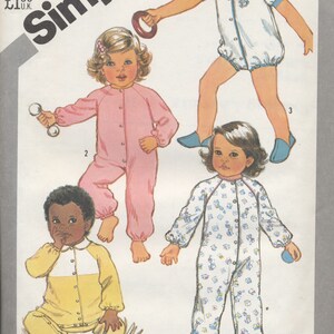 May include: Simplicity sewing pattern number 5593 for toddler pajamas. The pattern includes four different styles: a white pajama with blue trim, a pink pajama, a white pajama with a floral print, and a yellow and white pajama. The pattern is for sizes 3 toddler.