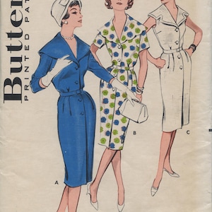 May include: Vintage sewing pattern for a dress with three different styles. The pattern is for a size 14, bust 34. The pattern is from Butterick and has the number 9305 on it.