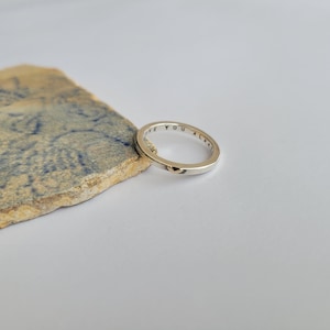 May include: A silver ring with a gold heart charm and the inscription "Love you always" engraved on the band.