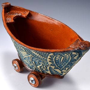 Small Stoneware Dory Boat with Wheels, Paprika Red glaze inside and Blue-Green stained outside with impressed abstract pattern