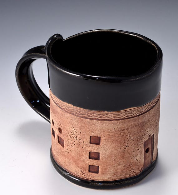 12 ounce mug featuring adobe house pattern with gloss Black Patent glaze