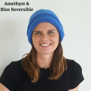 Pu&ograve; includere: Un berretto reversibile blu. Il berretto &egrave; di colore blu unito con una trama a coste. Il testo "Amethyst & Blue Reversible" si trova nell'angolo in alto a sinistra. La persona nell'immagine indossa una maglietta nera.
