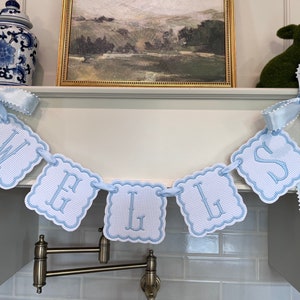 Baby blue embroidered name banner.