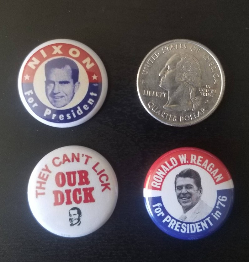 May include: Four political campaign buttons and a quarter. The buttons feature images of Richard Nixon and Ronald Reagan, with text that reads "Nixon for President" and "Ronald W. Reagan for President in '76". One button has the text "They Can't Our Dick".