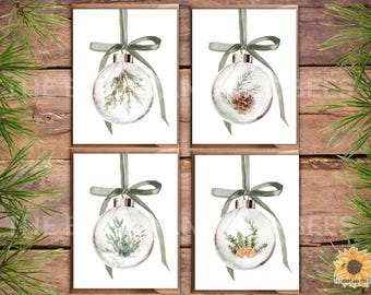May include: Four Christmas cards with watercolour illustrations of clear baubles filled with winter greenery. Each bauble is suspended by a green ribbon and bow. The cards are set against a rustic wooden background.