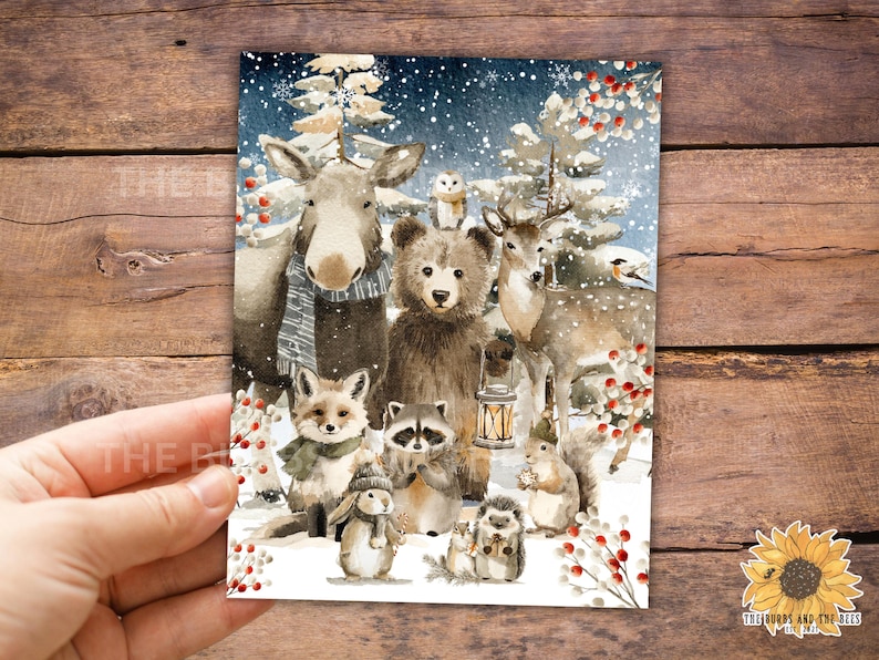 May include: A watercolour illustration depicting a winter woodland scene with various animals. The image includes a moose, bear, deer, fox, raccoon, owl, rabbit, squirrel, and hedgehog, set against a snowy backdrop with trees and red berries.