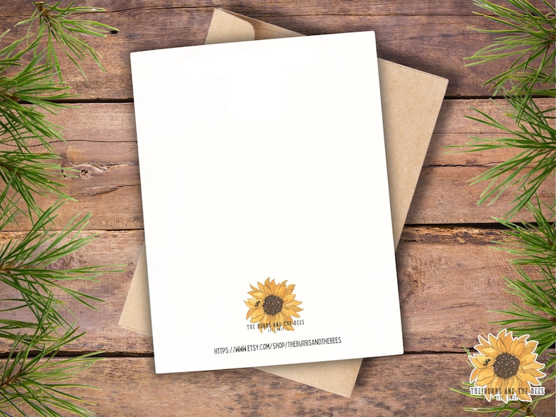 May include: A white greeting card with a brown kraft paper envelope. The bottom center of the card features a yellow sunflower illustration with a small bee, the text THE BURDS AND THE BEES EST 2021, and the URL HTTPS://WWW.ETSY.COM/SHOP/THEBURDSANDTHEBEES.