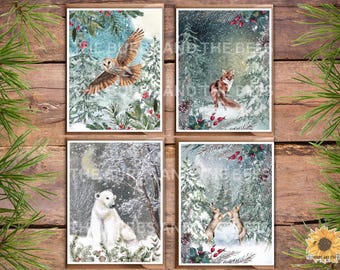 May include: Set of four winter-themed greeting cards featuring a snowy forest scene with a barn owl, a fox, a polar bear, and two hares. Each card has a watercolor-like style with a blue and green color scheme.
