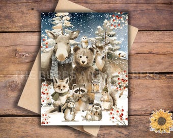 May include: A watercolour illustration of woodland animals in a snowy winter scene. The image features a moose, bear, deer, fox, raccoon, squirrel, owl, and hedgehog. The animals are surrounded by snow-covered trees and berries.