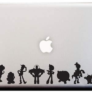 May include: Silhouette stickers of Toy Story characters, including Woody, Buzz Lightyear, Rex, and Mr. Potato Head, on a silver laptop.
