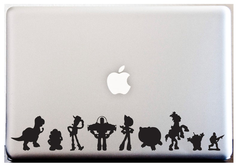 May include: Silhouette stickers of Toy Story characters, including Woody, Buzz Lightyear, Rex, and Mr. Potato Head, on a silver laptop.