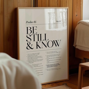 May include: A beige and white printable wall art poster with the text "Psalm 46" and "Be Still & Know" in black bold font. The poster also includes a portion of Psalm 46 in black text.