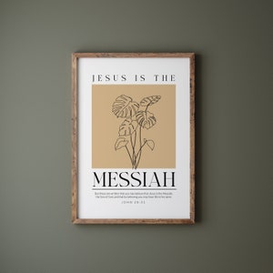 May include: A minimalist poster with a beige background and a black line drawing of a tropical plant. The text "JESUS IS THE MESSIAH" is in black and the text "But these are written that you may believe that Jesus is the Messiah, the Son of God, and that by believing you may have life in his name. JOHN 20:31" is in a smaller font.