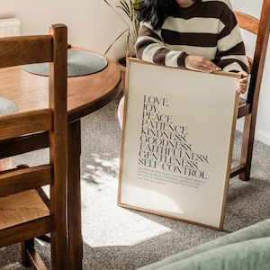 May include: A framed print with a white background and black text. The text reads "Love, Joy, Peace, Patience, Kindness, Goodness, Faithfulness, Gentleness, Self-Control." The text is followed by a Bible verse from Galatians 5:22-23.
