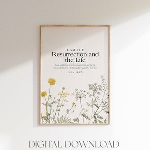 May include: A printable digital download featuring a quote from the Bible, "I am the resurrection and the life." John 11:25. The quote is surrounded by a watercolour illustration of yellow and green wildflowers.